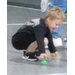  A little boy reaching down to pick up a plastic egg. 